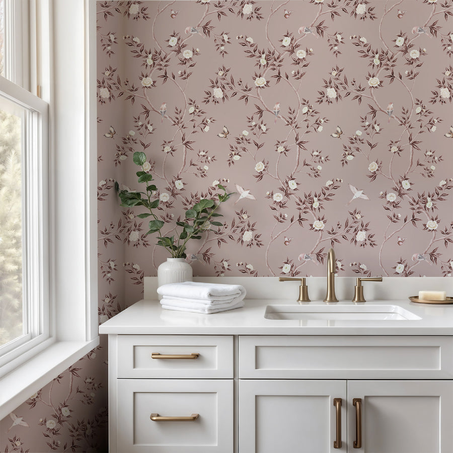 Bathroom with vanity cabinets and gold hardware featuring Dusty Rose Chinoiserie Hemma Wallpaper Floral Garden Birds accent wall