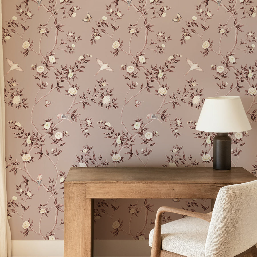 Dining area with wood table chair and table lamp featuring Dusty Rose Chinoiserie Hemma Wallpaper Floral Garden Birds accent wall