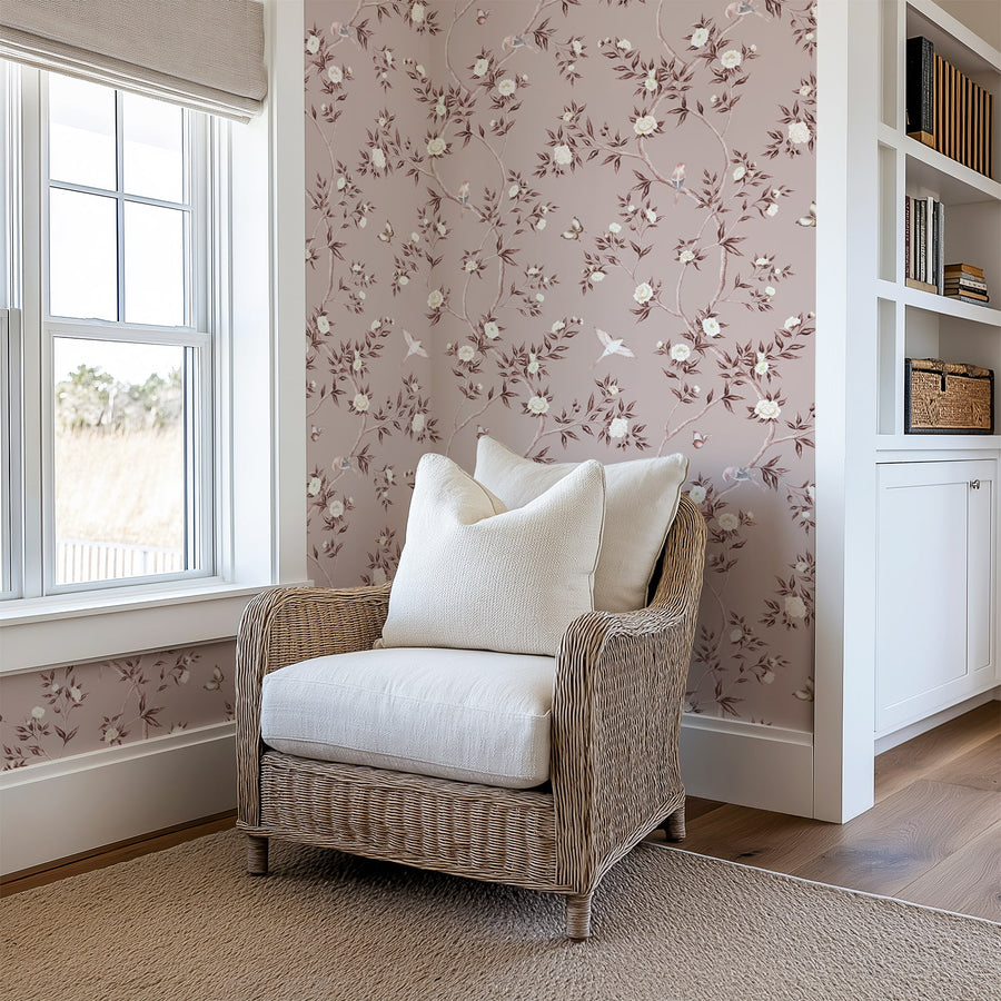 Reading corner with woven armchair cushion and window featuring Dusty Rose Chinoiserie Hemma Wallpaper Floral Garden Birds accent wall
