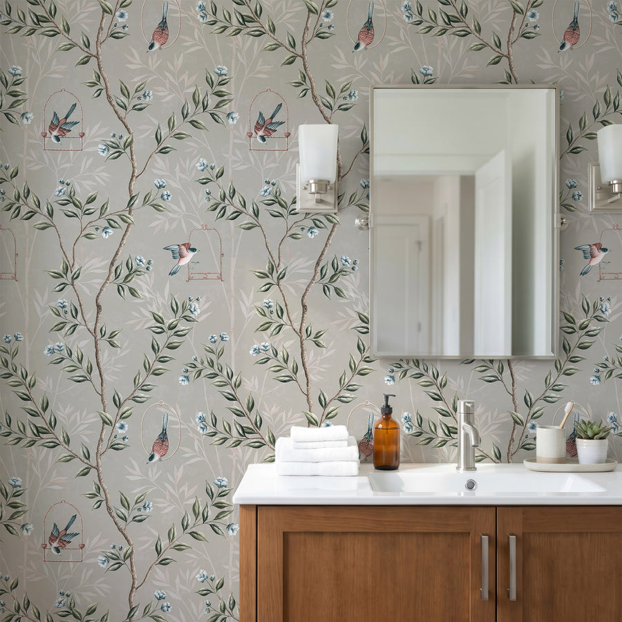 Bathroom with wood vanity framed mirror and wall sconces featuring Gray Chinoiserie Pauline Wallpaper Birds Branches by Maja Pitschmann