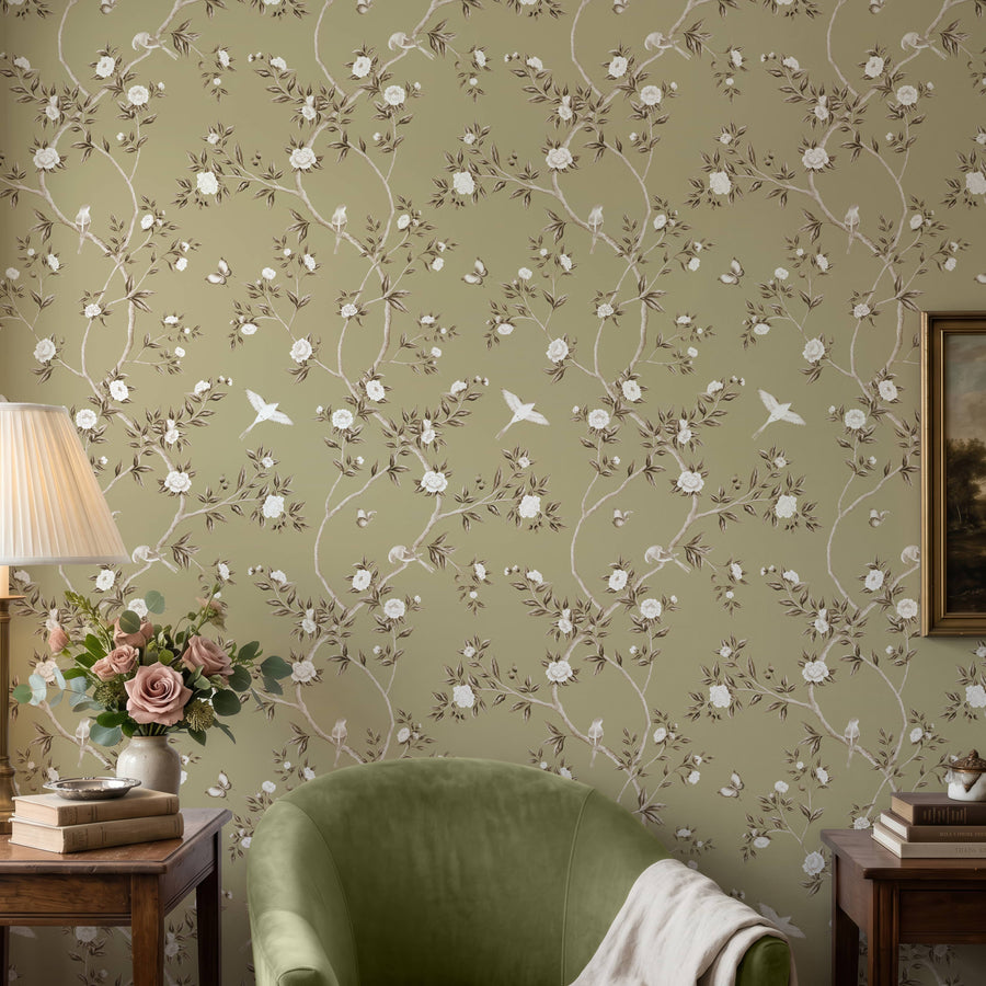 Living room with green velvet chair table lamp framed art and roses featuring Green Chinoiserie Hemma Wallpaper Floral Garden Birds by Maja Pitschmann