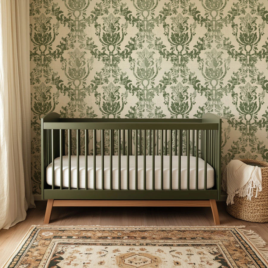 Sage green rococo damask wallpaper in a nursery with a crib