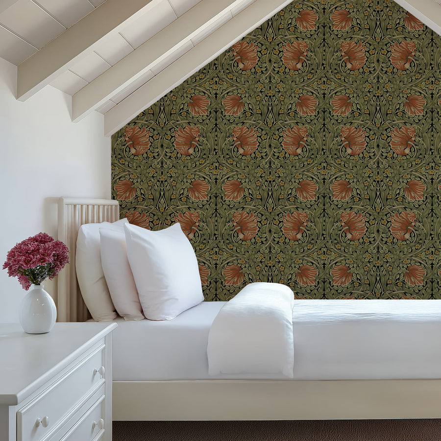 Green and terracotta William Morris Pimpernel wallpaper in a bedroom behind a bed