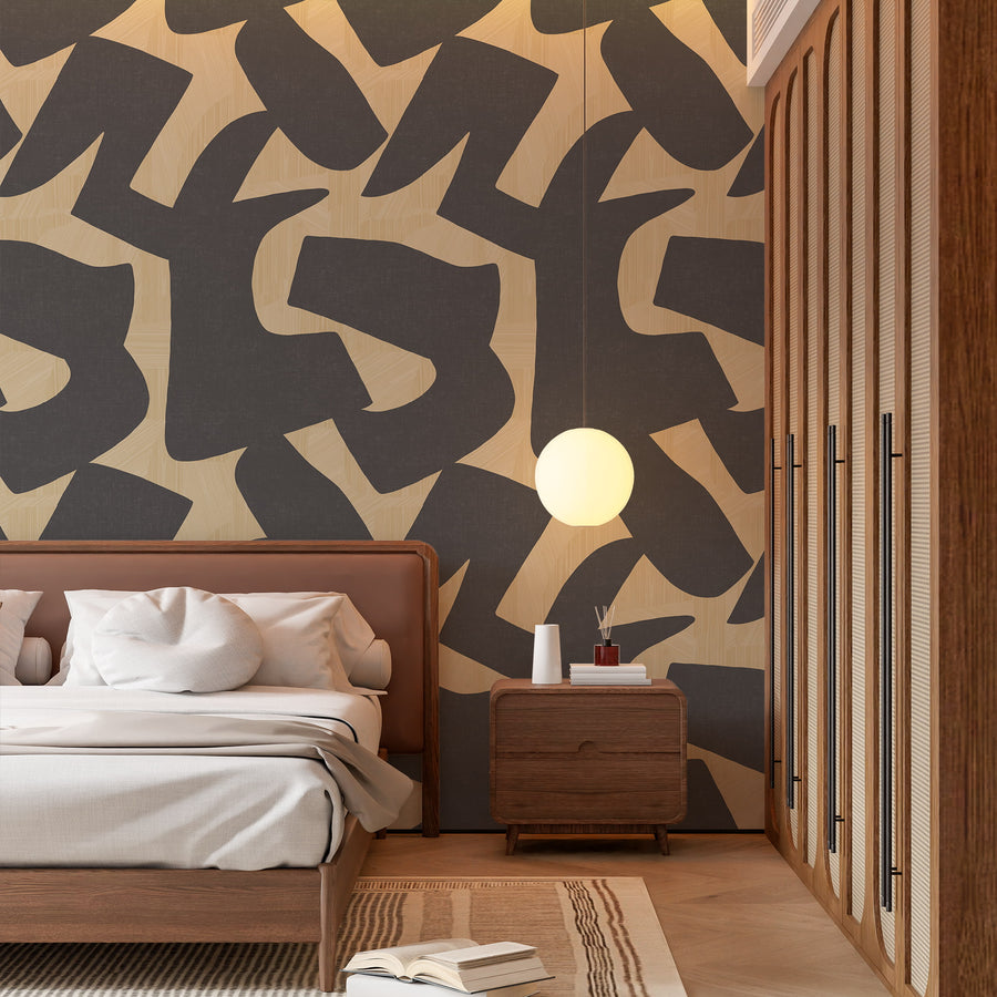 Intarsia charcoal and sand organic shapes wallpaper displayed in a styled interior vignette