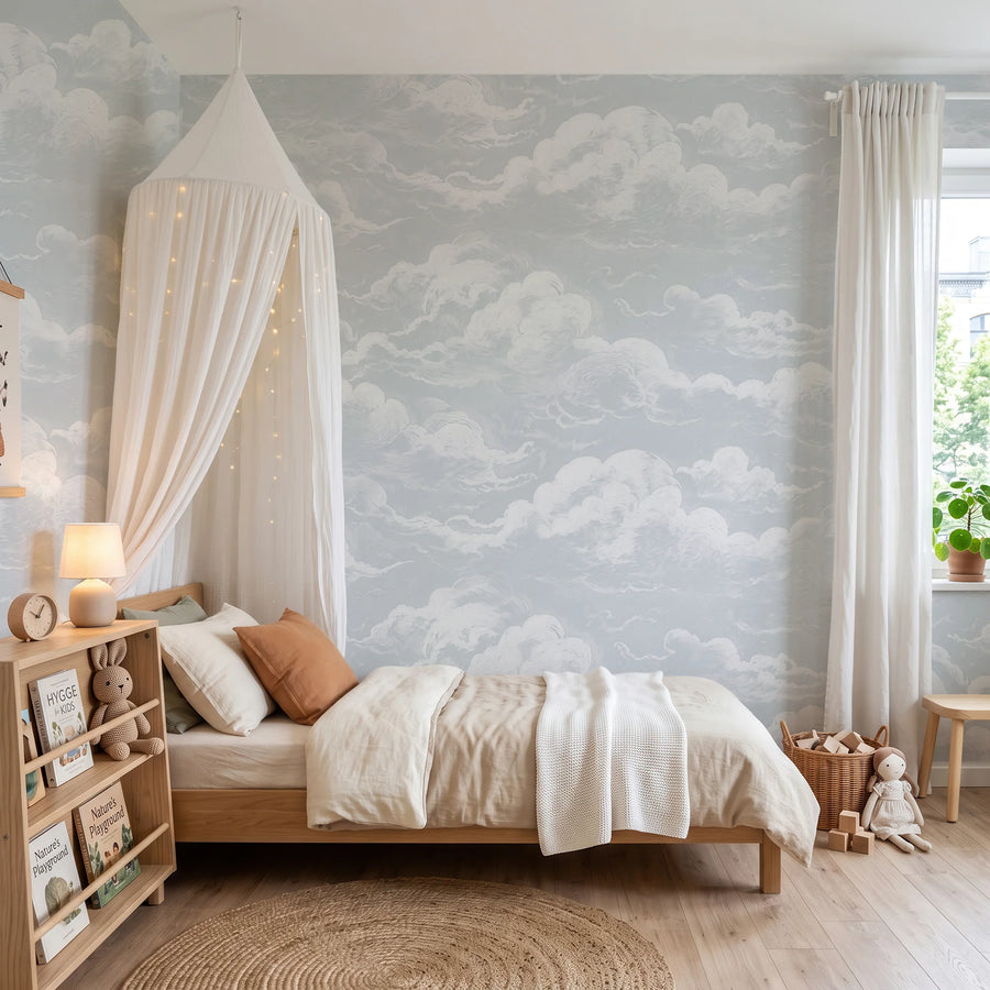 Light blue sky and clouds wall mural in a nursery with a canopy bed
