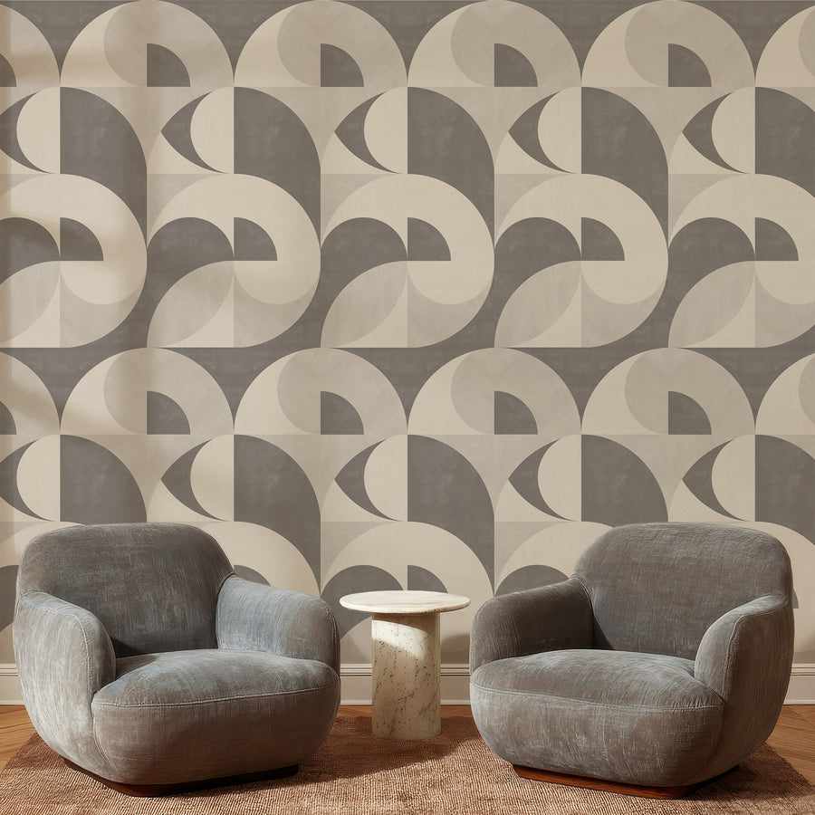 Lounge area with grey curved armchair featuring Mid-Century Neutral Geometric Wallpaper Taupe Cream accent wall