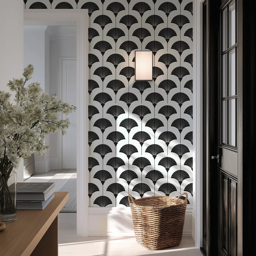 Black and white Art Deco fan wallpaper in an entryway beside a dark paneled door and basket