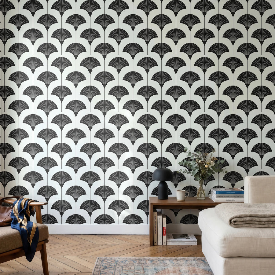 Black and white Art Deco fan wallpaper in a living room with a cream sofa and wood console