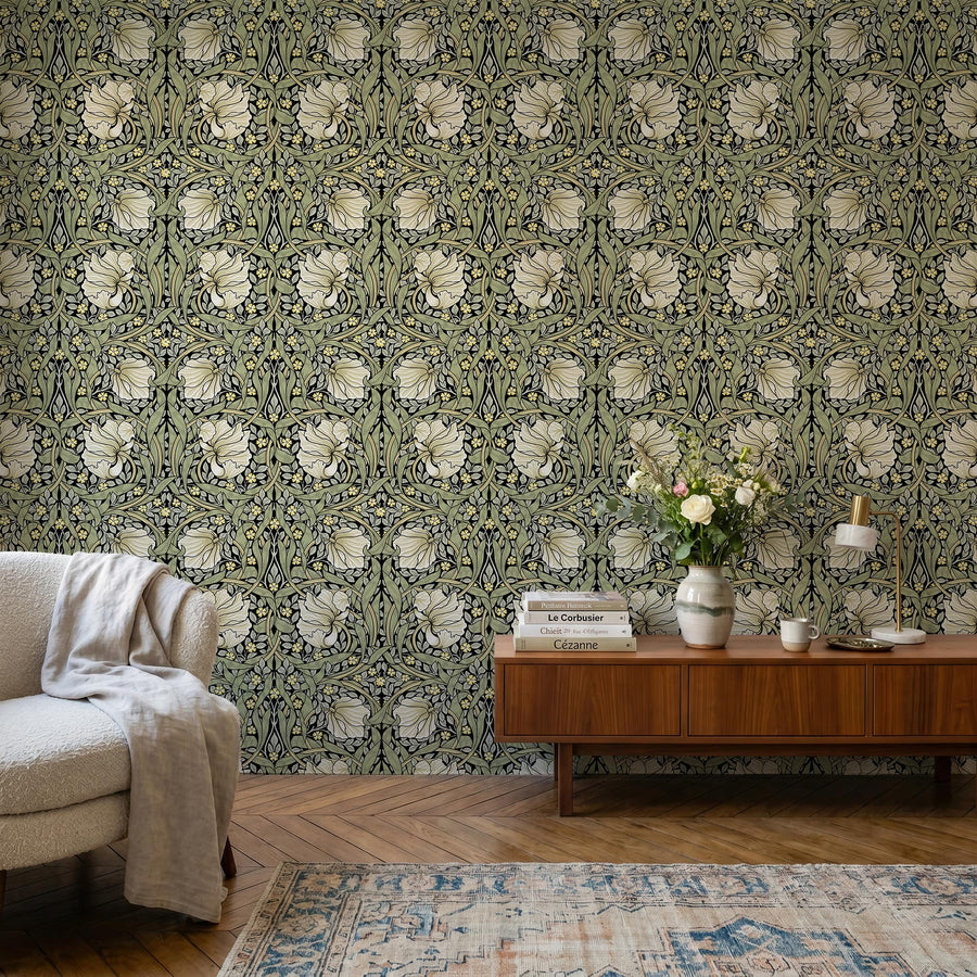 Olive green and cream William Morris Pimpernel wallpaper in a study behind a wood desk