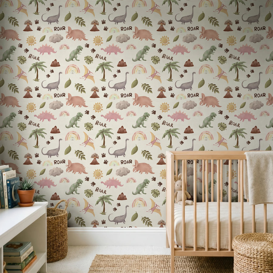 Blush and cream dinosaur rainbow nursery wallpaper behind a wooden crib and low white shelf