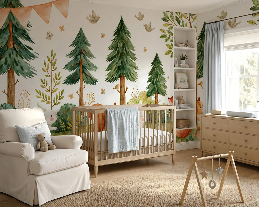 Pine tree woodland animals mural across a nursery wall with an armchair, crib and wooden play gym