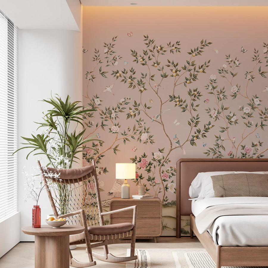 Pink chinoiserie crane wallpaper mural in a bedroom behind an upholstered bed