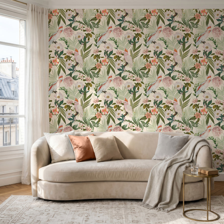 Pink cockatoo tropical floral wallpaper in a living room behind a cream sofa