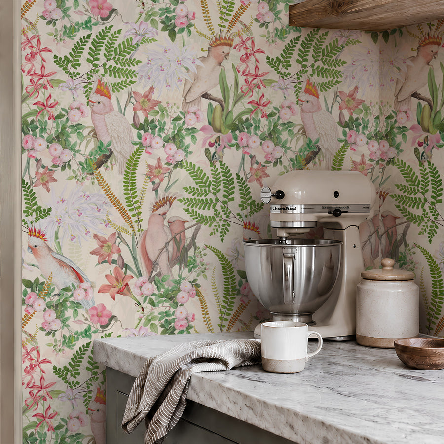 Pink parrots and green fern tropical wallpaper in a kitchen with marble counter