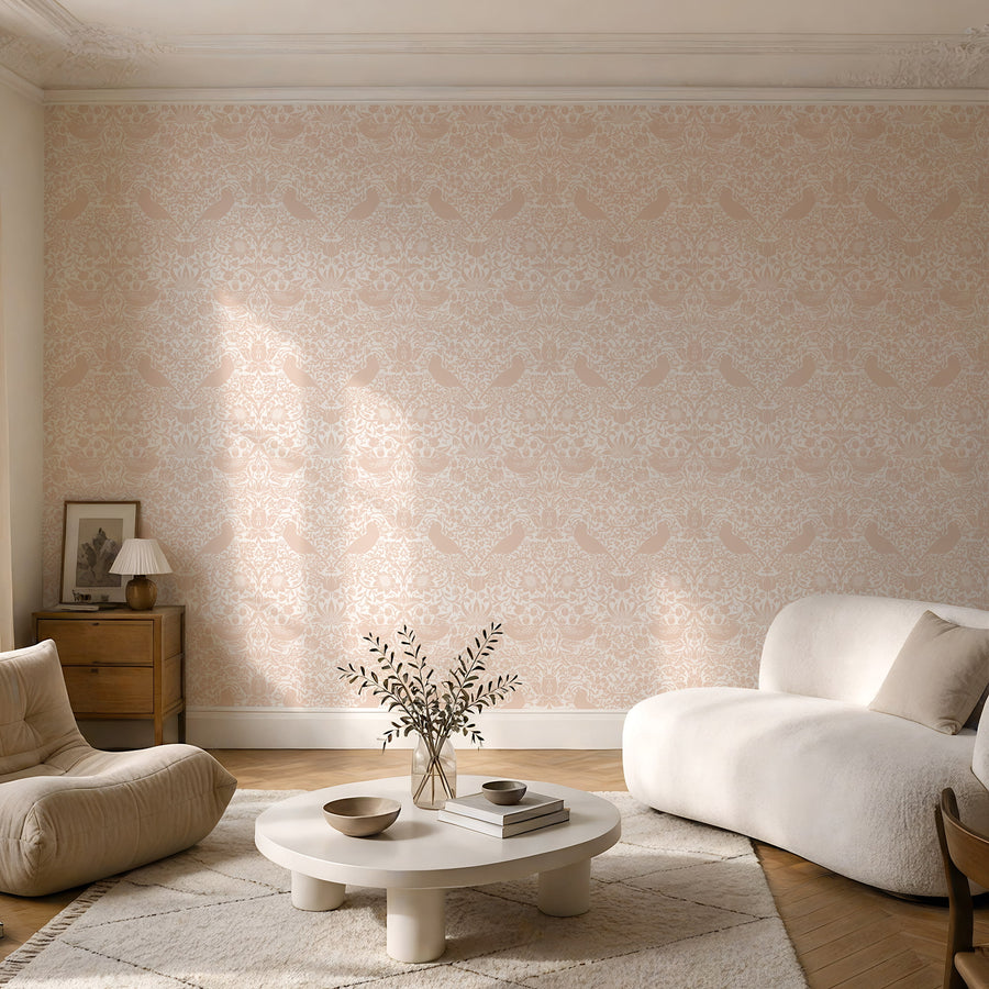 William Morris Strawberry Thief blush pink wallpaper in a sitting room with a boucle chair