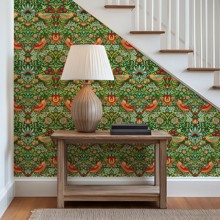 William Morris Strawberry Thief green wallpaper on a stair landing beside a console
