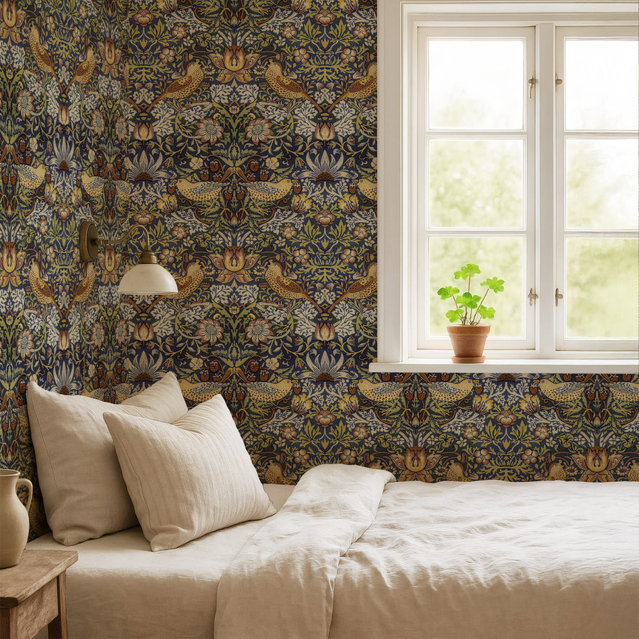 William Morris Strawberry Thief navy wallpaper in a bedroom with linen bedding