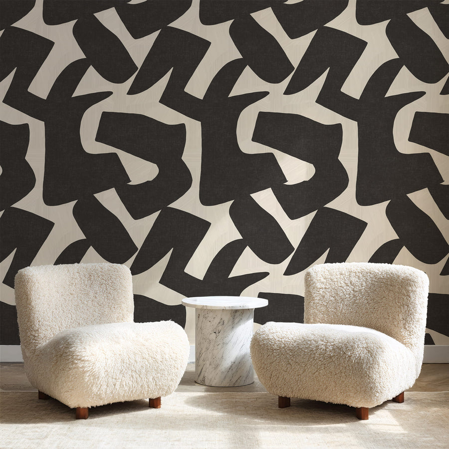 Woodland Intarsia black and cream organic shapes wallpaper displayed in a styled interior vignette